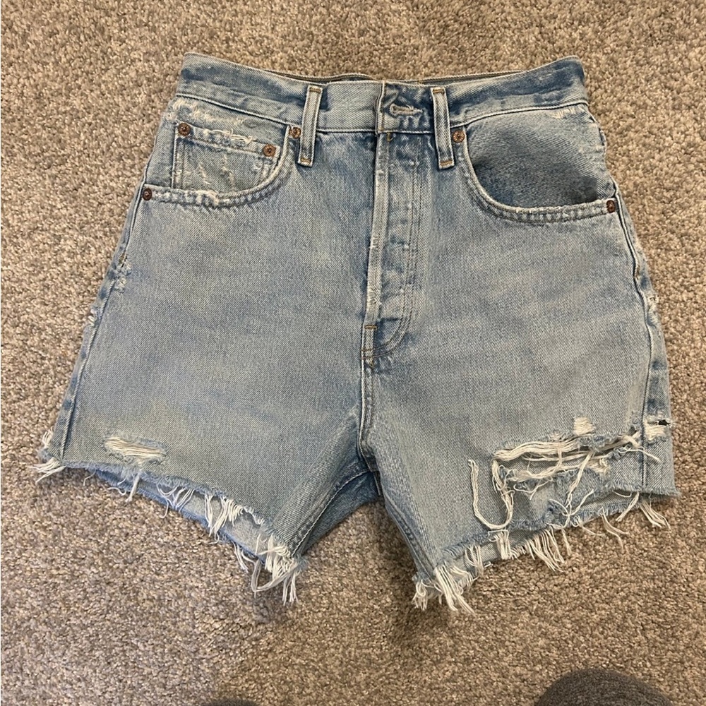 AGOLDE "Parker" shorts in distressed light-wash denim.
Mid-rise waist.